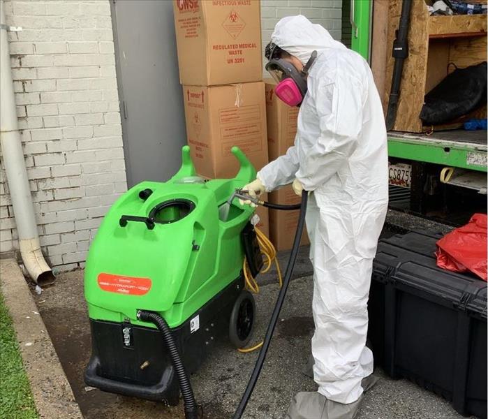 A SERVPRO professional cleaning dirty equipment 