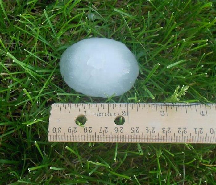 Two inch hail ball in Maryland grass.