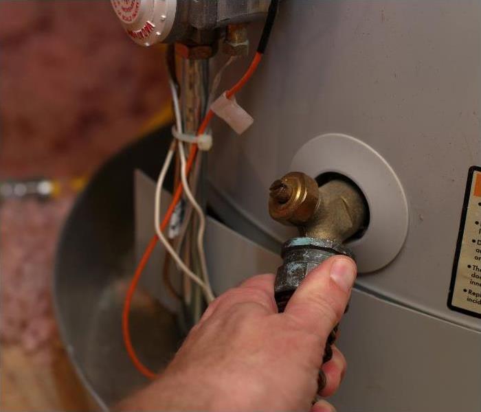 A water heater being maintained after a burst